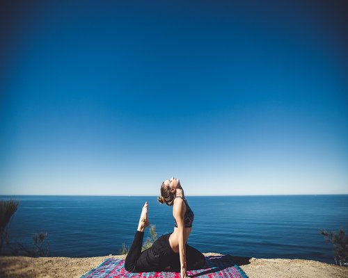 woman doing yoga stretching near window